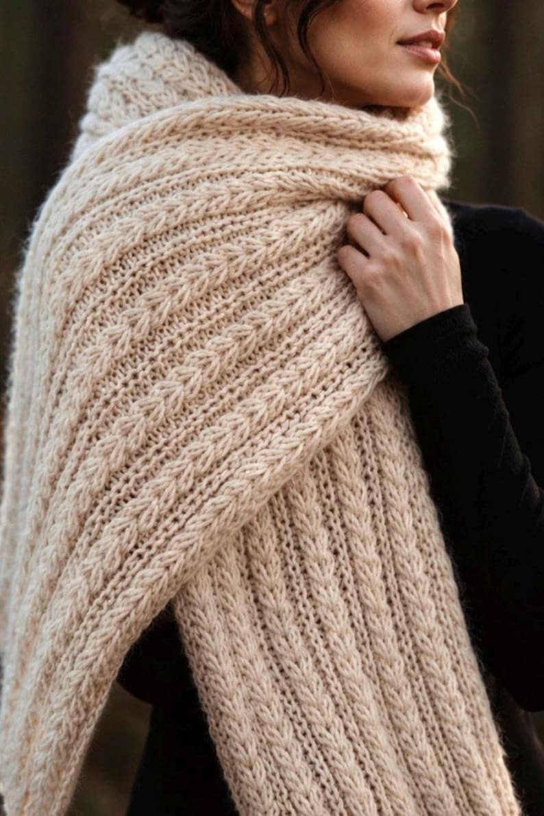 Knitting pattern scarf folded on neutral background, cozy chunky knit accessory display. easy scarf knitting pattern, chunky knit scarf pattern. Warm wrap scarf knitting pattern, oversized women's knit scarf in worsted weight yarn, easy beginner cozy knit wrap PDF instant download. women knit scarf pattern, easy knitting pattern. rectangle scarf knit pattern. chunky heart scarf knit pattern