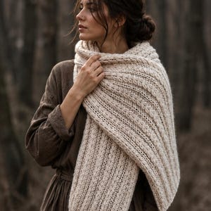 Knitting pattern scarf folded on neutral background, cozy chunky knit accessory display. easy scarf knitting pattern, chunky knit scarf pattern. Warm wrap scarf knitting pattern, oversized women's knit scarf in worsted weight yarn, easy beginner cozy knit wrap PDF instant download. women knit scarf pattern, easy knitting pattern. rectangle scarf knit pattern. chunky heart scarf knit pattern