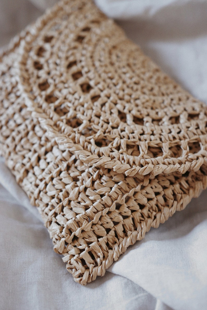 Raffia clutch crochet pattern, straw bag crochet pattern. crochet straw purse pattern. crochet raffia purse tote pattern. easy crochet purse. crochet tote handbag. straw summer bag crochet pattern. beginner crochet bag pattern.  Sunrise Clutch Crochet Pattern, Raffia Clutch Bag Crochet Pattern, Straw Summer Bag Crochet Pattern, Bag Crochet Pattern, Raffia Clutch Crochet Pattern, Summer Bag Crochet Pattern, Easy Crochet Patterns, Beginner Crochet Pattern, Tote Crochet Pattern