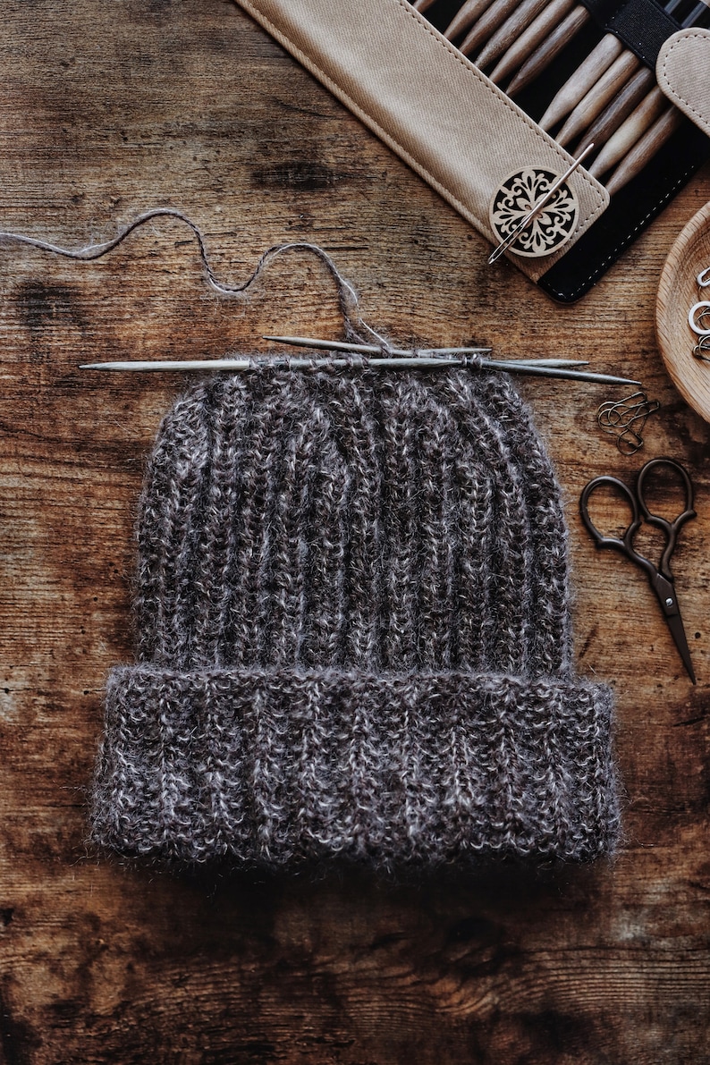 A beanie in the process of being knitted. This easy knitting pattern is designed for men.