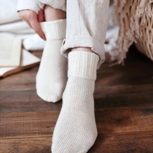 Knitting pattern pages close-up, basic socks knit instructions detail. basic socks knitting pattern. fold over socks knit pattern. easy knit women socks. top down knit socks pattern. cream white knit socks pattern. beginner socks knitting pattern. adult women knit socks pattern. classic knit socks.