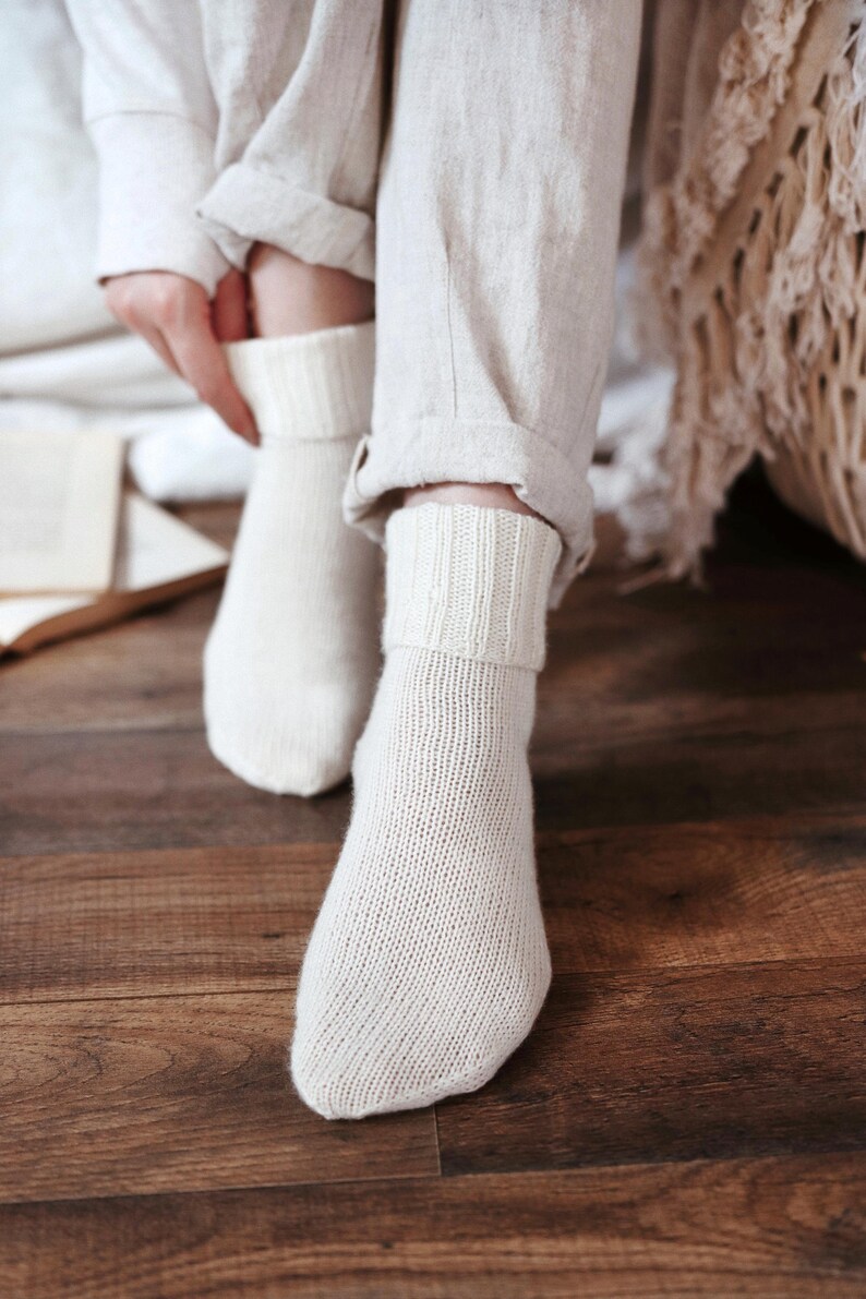 Knitting pattern pages close-up, basic socks knit instructions detail. basic socks knitting pattern. fold over socks knit pattern. easy knit women socks. top down knit socks pattern. cream white knit socks pattern. beginner socks knitting pattern. adult women knit socks pattern. classic knit socks.
