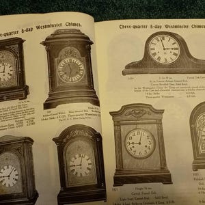 May include: A page from a catalog featuring three-quarter 8-day Westminster Chimes clocks. The clocks are made of wood and have a polished walnut finish. The clocks have a Roman numeral dial and a silver gong. The clocks are available in different sizes and styles.