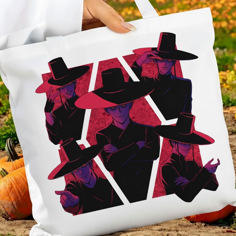 May include: White tote bag featuring a graphic of five figures in black outfits and wide-brimmed hats. The figures are set against a red patterned background within a white geometric shape. The artwork has a manga or anime style.