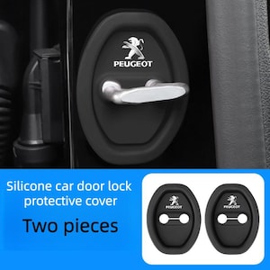 May include: Black silicone car door lock protective covers featuring the Peugeot logo. The image shows two pieces, with the text "Two pieces" below. These covers are designed to protect car door locks.
