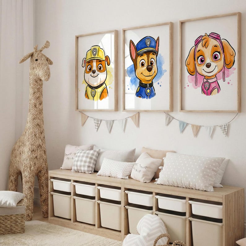 May include: Three framed watercolor prints of cartoon dogs from Paw Patrol. Each dog is wearing a uniform and has a unique expression. The prints are displayed above a storage bench with white bins. A large giraffe sculpture stands to the left.