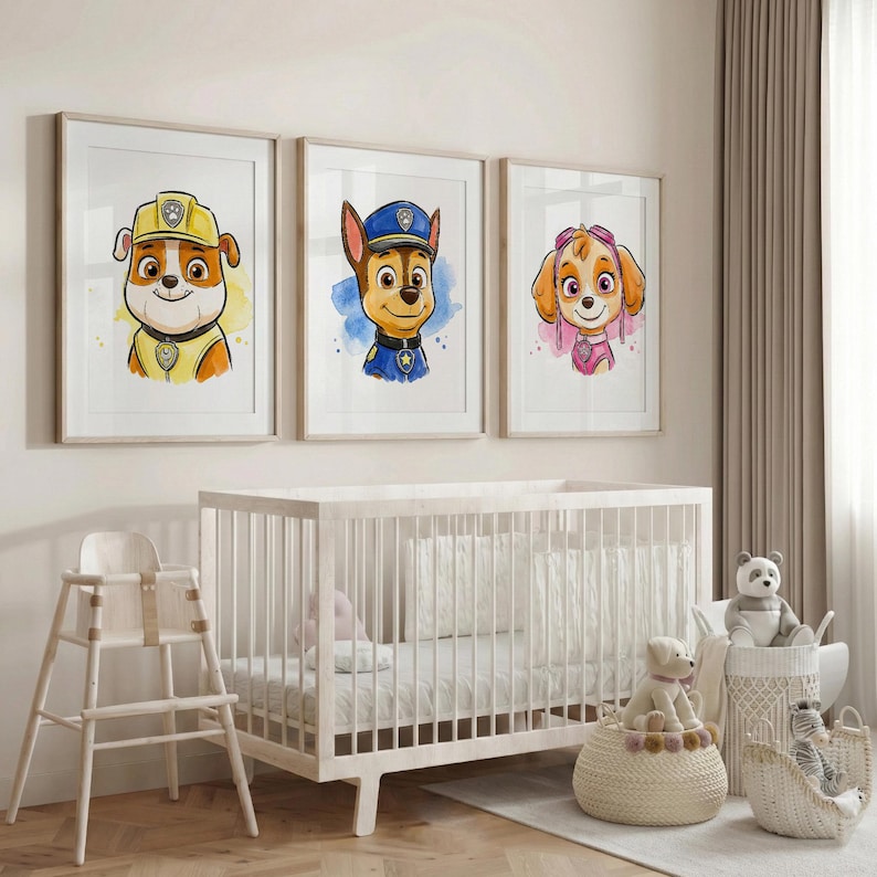 May include: Three framed watercolor prints featuring cartoon dog characters in hats and uniforms. The prints are displayed above a white crib in a nursery setting. The characters are in yellow, blue, and pink, with watercolor backgrounds.