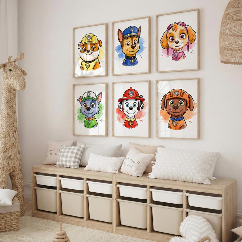 May include: Six framed watercolor prints featuring cartoon dogs from the Paw Patrol series. Each print showcases a different character with vibrant colors and a watercolor background. The prints are displayed above a wooden storage unit with white bins.