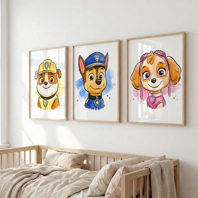 May include: Three framed watercolor prints featuring characters from the Paw Patrol series. Each print showcases a different puppy character with vibrant colors and a watercolor background. The prints are displayed above a wooden crib.