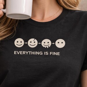 May include: A trio of ceramic mugs with a speckled, matte finish in cream, light grey, and dark grey. Each mug features a minimalist design and a rounded handle.