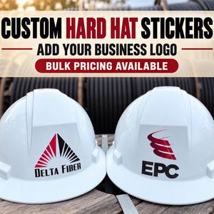 May include: Two white hard hats featuring custom company logos. The left hat displays a red and black Delta Fiber triangle logo. The right hat shows a red and black EPC logo. Text above reads: CUSTOM HARD HAT STICKERS, ADD YOUR BUSINESS LOGO.