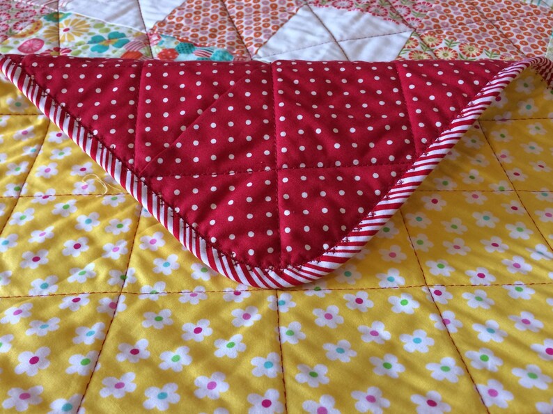 Pink Yellow and More Are All Together In This 40.5 X 49.5 Quilt In The Line Called So Happy By Deena Rutter For Riley Blake Red Aqua