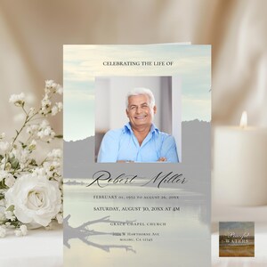May include: A memorial card with a photo of a smiling man in a blue shirt. The card reads "Celebrating the Life of Robert Miller" with dates and service details. The background features a serene landscape.