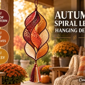 May include: A hanging spiral leaf decoration made of crocheted yarn in shades of burgundy, orange, and cream. The piece features a central vertical structure with seven leaf-shaped segments and a multi-colored tassel at the bottom.