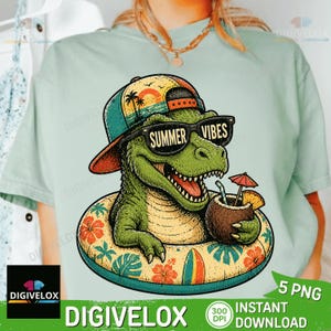 May include: A light blue t-shirt featuring a cartoon dinosaur wearing sunglasses with the text "Summer Vibes." The dinosaur is in a pool float with a tropical drink. The design includes a hat with a sunset and palm trees.