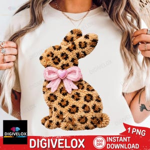 May include: A decorative bunny design with a leopard print pattern. The bunny has a pink bow with a heart-shaped center. The image includes the text "DIGIVELOX" and "INSTANT DOWNLOAD".