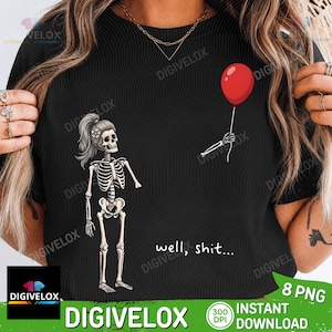 May include: A black t-shirt featuring a graphic of a skeleton with a ponytail and a flower in its hair, looking at a floating red balloon held by a detached skeletal hand. The text "well, shit..." is printed in white below the skeleton.