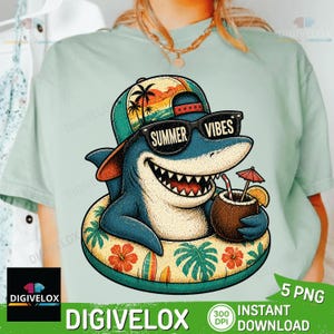 May include: A light blue t-shirt featuring a cartoon shark wearing sunglasses with the text "SUMMER VIBES". The shark is in a floatie and holding a coconut drink. The shirt has a tropical theme.