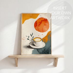 May include: Abstract art print featuring a coffee cup with latte art on a saucer. The artwork has a warm color palette with orange, yellow, and teal accents. The print is in a wooden frame and sits on a wooden shelf.