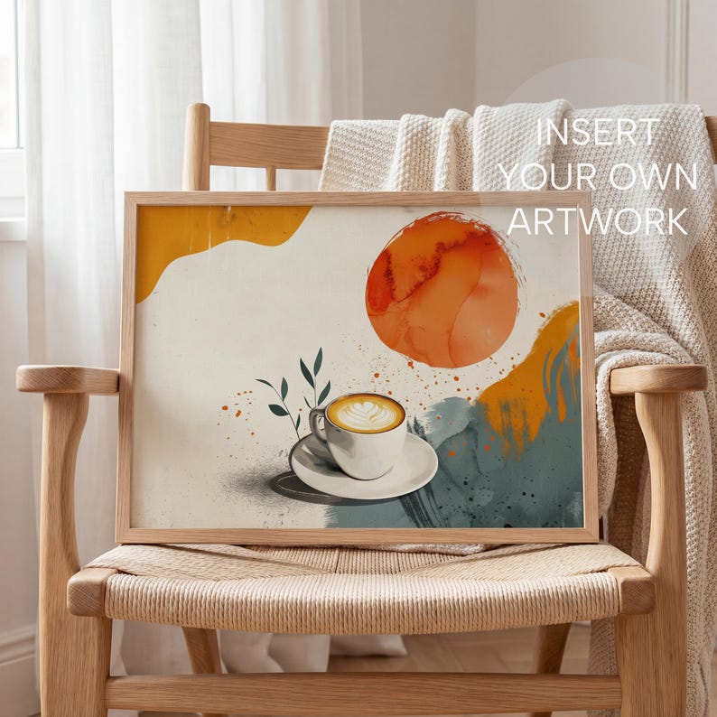 May include: A framed art print featuring a watercolor illustration of a coffee cup with latte art, set against a backdrop of abstract shapes in orange, yellow, and teal. The artwork is in a light wood frame, with the text "INSERT YOUR OWN ARTWORK".