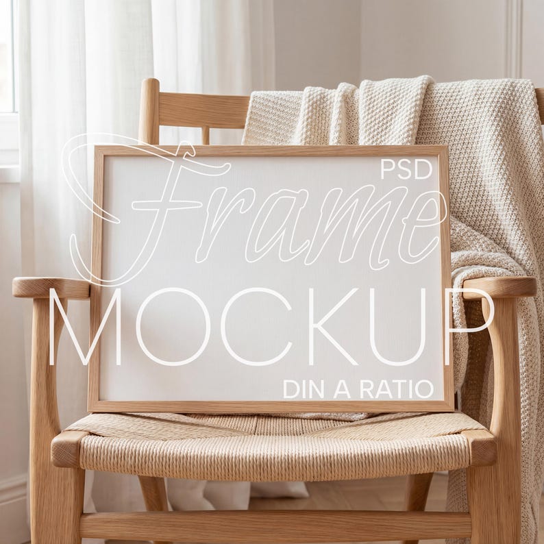 May include: A rectangular wooden frame mockup with the text "Frame Mockup" and "PSD DIN A RATIO" in white, resting on a woven chair. A beige blanket is draped over the chair's back. The scene is bathed in natural light.