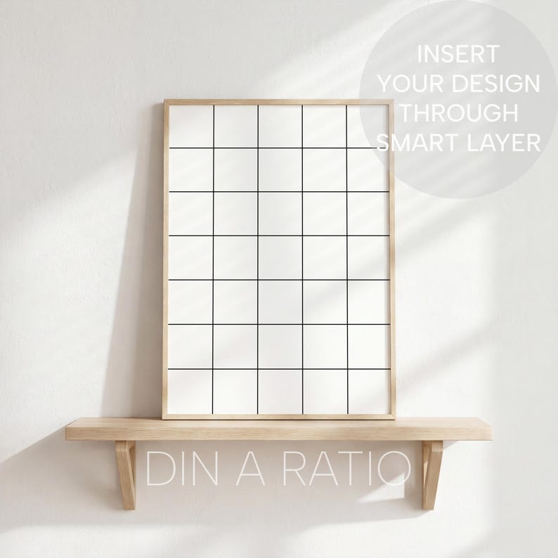 May include: A framed grid design with a light wood frame, resting on a wooden shelf. The grid is divided into equal squares by black lines. The text "INSERT YOUR DESIGN THROUGH SMART LAYER" is visible. Below the shelf, the text "DIN A RATIO" is displayed.