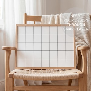 May include: A wooden framed grid board with a white interior and black grid lines. The board is propped on a light wood chair with a woven seat. The text "INSERT YOUR DESIGN THROUGH SMART LAYER" is visible on the board.