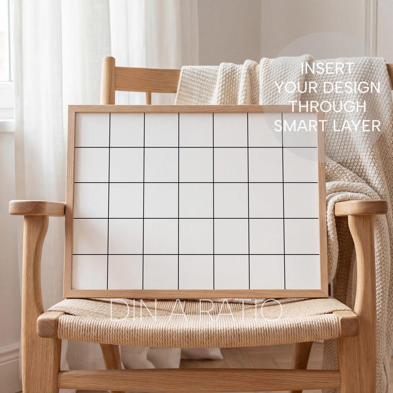 May include: A wooden framed grid board with a white interior and black grid lines. The board is propped on a light wood chair with a woven seat. The text "INSERT YOUR DESIGN THROUGH SMART LAYER" is visible on the board.
