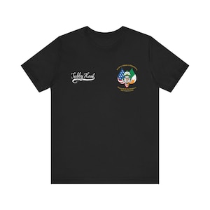 May include: Black t-shirt with the text "Tubby Hook" in white script on the left chest. The right chest features a crest with the American and Irish flags, and the text "Ancient Order of Hibernians, William R. Grace Division, New York County."