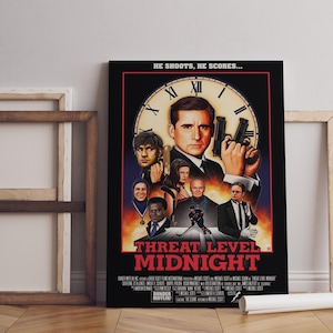May include: A framed poster for "Threat Level Midnight" featuring a central image of a man holding two guns. The poster has a clock design and includes the text "He shoots, he scores..." and "Dunder Mifflin".
