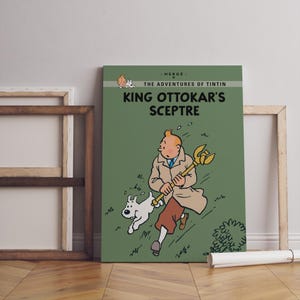 May include: A canvas print of "King Ottokar's Sceptre" from The Adventures of Tintin. The artwork features Tintin, his dog Snowy, and a golden scepter against a green background. The print is displayed with a wooden frame.
