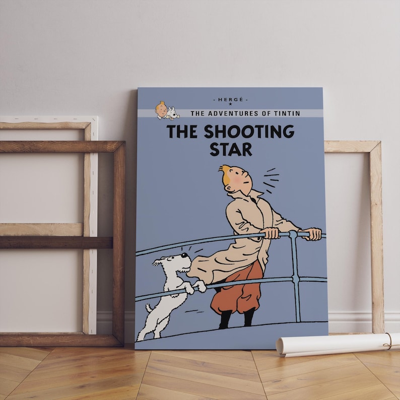 May include: A canvas print of "The Shooting Star" from The Adventures of Tintin. The artwork features Tintin, his dog Snowy, and the title text in bold white letters against a blue background. The print is displayed with a wooden frame.