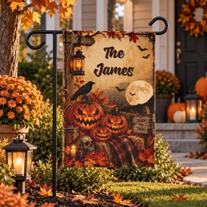 May include: A rectangular garden flag featuring a Halloween theme with three carved jack-o'-lanterns, a black crow, a skull, and a lantern hanging from a wooden post. The text reads The James and Trick or Treat against a moonlit autumn background.
