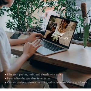 May include: A silver laptop displaying a digital wedding invitation template on its screen. The screen shows a photograph of a couple with the white cursive text Olivia & James overlaid. The laptop is open on a wooden surface with text below.