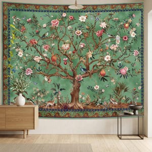 May include: A large green tapestry with a detailed illustration of a tree with flowers, birds, and fruit. The tree is brown with pink, white, and red flowers. The tapestry has a dark green border with a blue floral design.