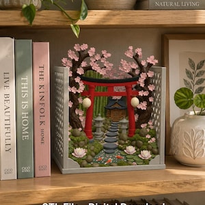 May include: A 3D printed book nook insert featuring a red torii gate, two cherry blossom trees with pink flowers, a stone path, a small temple, and a pond with orange koi fish and pink water lilies, enclosed in a gray lattice frame.