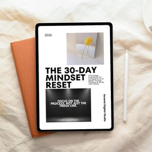 May include: A digital tablet displaying a graphic with the text "THE 30-DAY MINDSET RESET" and "FOCUS ON THE PROCESS, NOT JUST THE FINISH LINE." A yellow tulip image is also displayed. An orange notebook and a white stylus are next to the tablet.
