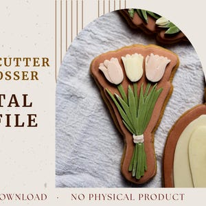 May include: A decorated cookie shaped like a bouquet of tulips. The cookie has three tulips, two pink and one white, with green stems and leaves. The cookie is on a white surface. Text on the left says "Shape Me Sweet, Cookie Cutter & Debosser, Digital STL File".