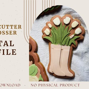 May include: A decorated cookie in the shape of a pair of boots filled with green grass and white tulips. The cookie is brown with white, green, and tan icing. Text on the image reads "COOKIE CUTTER & DEBOSSER DIGITAL STL FILE".