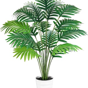 May include: A large artificial palm plant with vibrant green fronds and slender stems. The plant is potted in a white, ribbed planter filled with dark pebbles. The leaves have a layered appearance, creating a full, lush look.