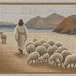 May include: A needlepoint canvas featuring a figure in a long white robe walking on a sandy beach with a large flock of sheep. The scene includes a blue body of water and brown hills in the background, all framed by a solid brown border.