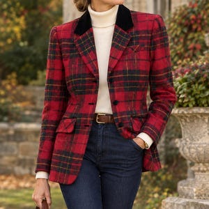 May include: A red and black plaid blazer with a black velvet collar, worn over a cream-colored turtleneck sweater and dark blue denim jeans. The blazer features a button-front closure and two flap pockets. A brown leather belt and handbag are included.