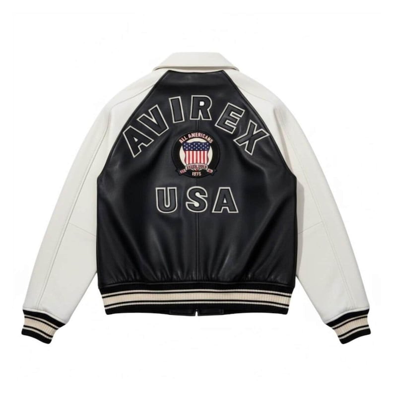 Front view of black and white Avirex USA leather varsity bomber jacket with embroidered chest patch, zip front closure, striped ribbed hem and cuffs, handmade premium leather jacket
