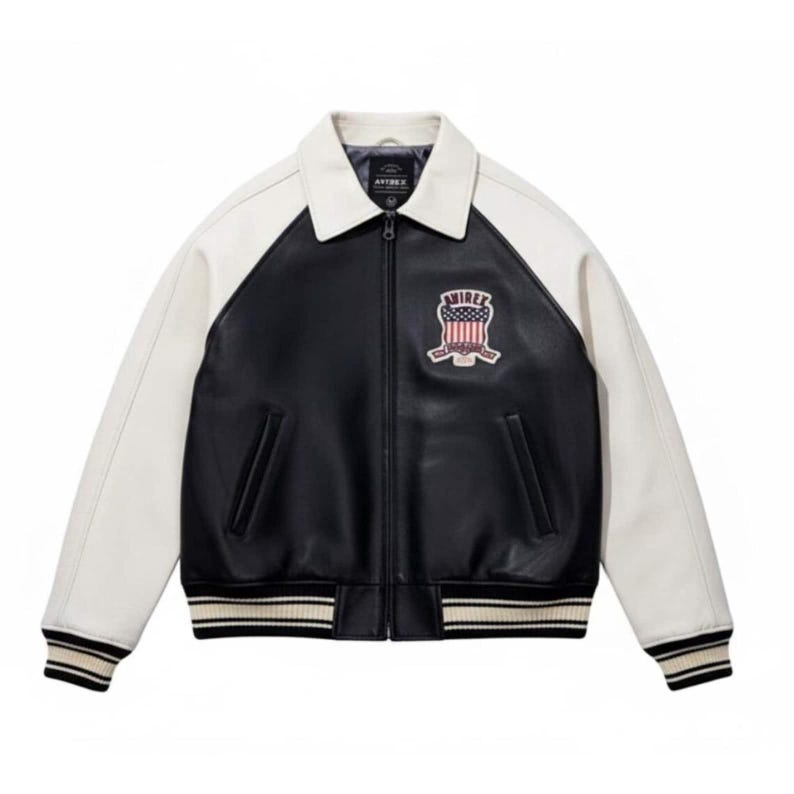 Back view of black and white Avirex USA leather varsity jacket featuring oversized AVIREX USA lettering, embroidered American crest, striped ribbed waistband, vintage bomber style