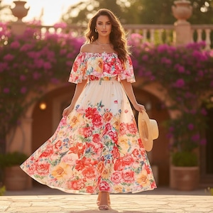 May include: A long, off-the-shoulder floral dress with a flowing skirt. The dress features a vibrant pattern of red, yellow, and pink roses on a cream background. A straw hat is held in the hand. The dress is suitable for a summer occasion.