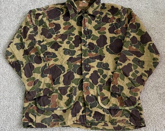 Chaqueta Saftbak vintage para hombre, talla XL, lona verde camuflaje, ideal para caza y actividades al aire libre, con botones y bolsillos.