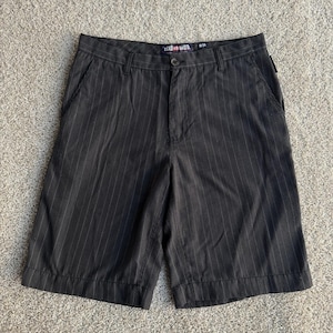 May include: Dark brown pinstripe shorts with a button closure and pockets. The shorts have a classic design and the brand name "Ecko Unltd." is visible on the waistband. The shorts are size W-34.