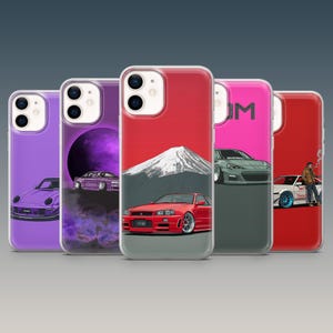 May include: A collection of five phone cases featuring car illustrations. The cases showcase various car designs against colorful backgrounds, including a purple Porsche, a red car with a mountain, and a green car.