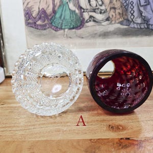 Top view of clear pressed glass base and interior of red glass shade labeled A