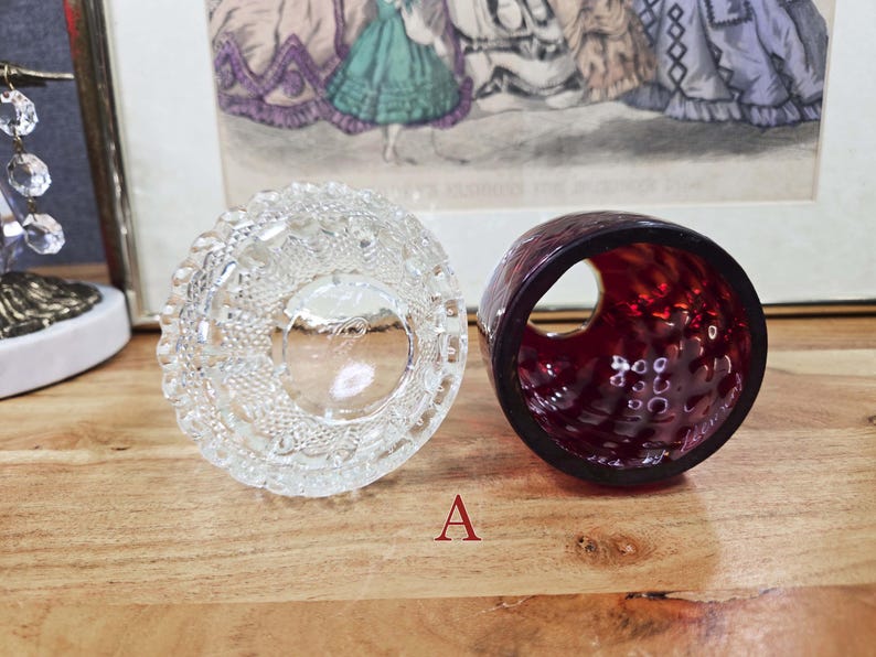 Top view of clear pressed glass base and interior of red glass shade labeled A